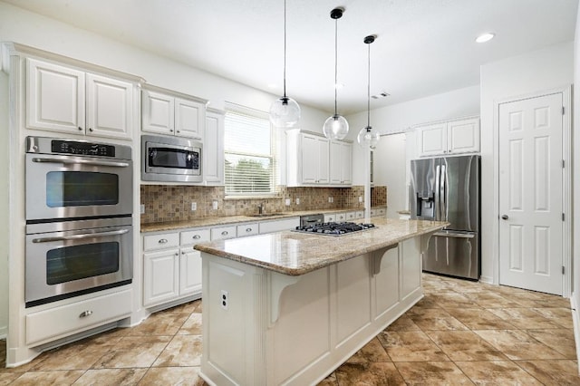 3340 Marcasite Dr, Round Rock, TX 78681 - kitchen featuring stainless steel appliances, backsplash, a center island, white cabinets, and recessed lighting