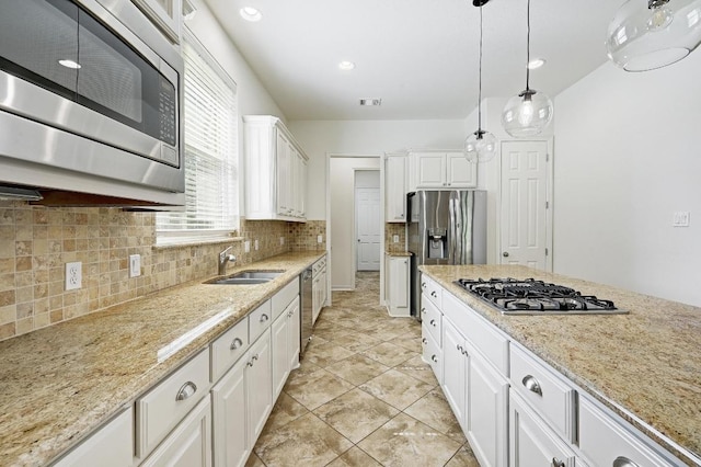 3340 Marcasite Dr, Round Rock, TX 78681 - kitchen featuring stainless steel appliances, backsplash, white cabinetry, decorative light fixtures, and light stone counters