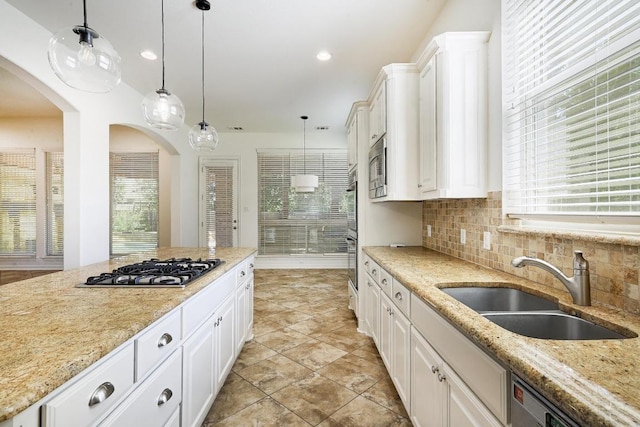 3340 Marcasite Dr, Round Rock, TX 78681 - kitchen with stainless steel appliances, decorative backsplash, hanging light fixtures, white cabinetry, and recessed lighting