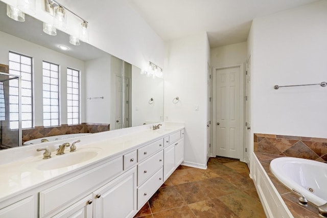3340 Marcasite Dr, Round Rock, TX 78681 - bathroom featuring double vanity, a whirlpool tub, and stone finish floors