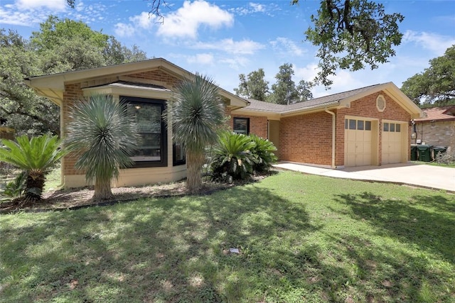 1928 Ramona Cir, San Marcos, TX 78666 - view of front of home featuring an attached garage, brick siding, concrete driveway, and a front lawn