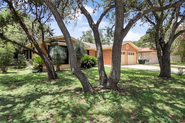1928 Ramona Cir, San Marcos, TX 78666 - view of front of home featuring a garage, brick siding, a front yard, and concrete driveway