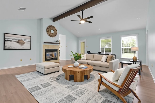 1928 Ramona Cir, San Marcos, TX 78666 - living area with wood finished floors, a ceiling fan, and a tile fireplace