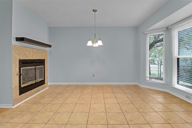 1928 Ramona Cir, San Marcos, TX 78666 - unfurnished living room featuring a chandelier, light tile patterned floors, and a tiled fireplace