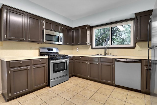 1928 Ramona Cir, San Marcos, TX 78666 - kitchen featuring stainless steel appliances, light countertops, and light tile patterned floors