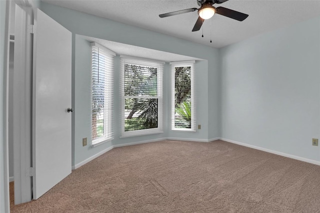 1928 Ramona Cir, San Marcos, TX 78666 - carpeted empty room featuring plenty of natural light, a textured ceiling, and ceiling fan