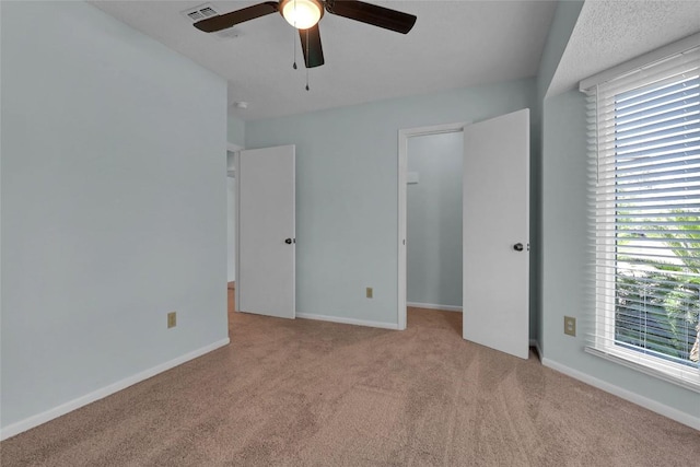 1928 Ramona Cir, San Marcos, TX 78666 - unfurnished bedroom with carpet flooring, multiple windows, and ceiling fan