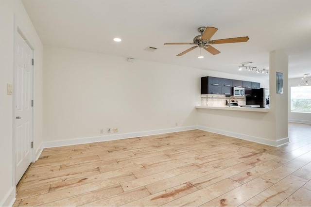 1101 Grove Blvd Unit 102, Austin, TX 78741 - unfurnished living room with light wood finished floors, ceiling fan, track lighting, and recessed lighting