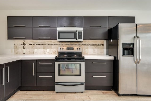 1101 Grove Blvd Unit 102, Austin, TX 78741 - kitchen featuring stainless steel appliances, light countertops, backsplash, and light wood-style flooring