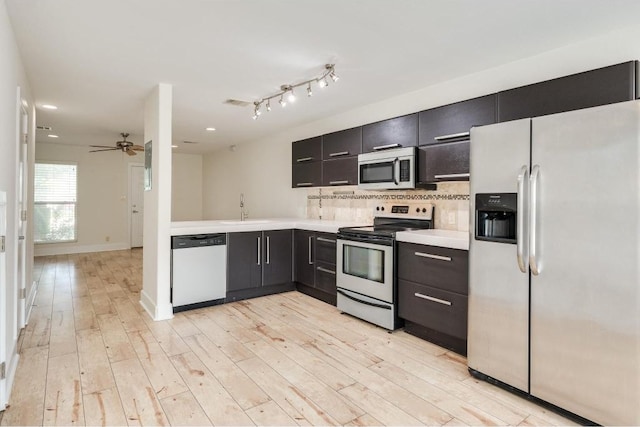 1101 Grove Blvd Unit 102, Austin, TX 78741 - kitchen with appliances with stainless steel finishes, light countertops, decorative backsplash, light wood-style flooring, and ceiling fan