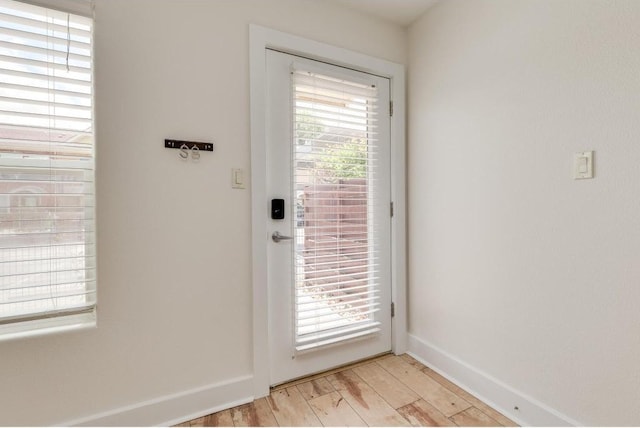 1101 Grove Blvd Unit 102, Austin, TX 78741 - doorway featuring light wood-style floors and baseboards