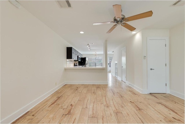 1101 Grove Blvd Unit 102, Austin, TX 78741 - unfurnished living room with light wood-style floors, a ceiling fan, and recessed lighting