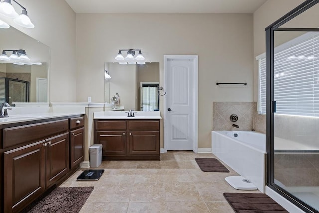 614 Spanish Mustang Dr, Cedar Park, TX 78613 - full bathroom featuring healthy amount of natural light, two vanities, a shower stall, and a garden tub