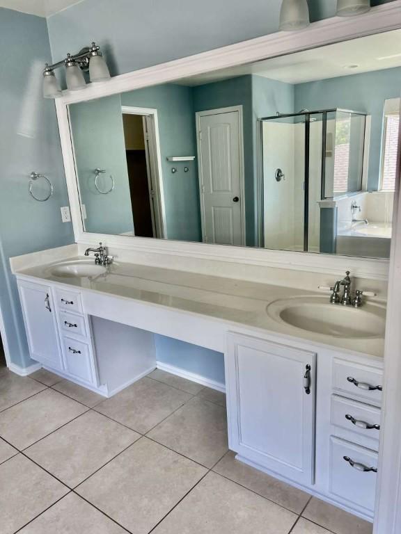 2118 Howell Mountain Dr, Cedar Park, TX 78613 - bathroom with double vanity, a shower stall, and tile patterned flooring