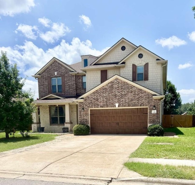 2118 Howell Mountain Dr, Cedar Park, TX 78613 - view of front of home with an attached garage, driveway, and brick siding