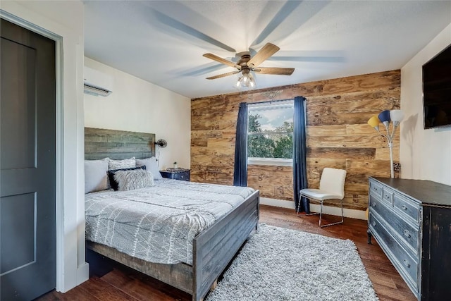 20008 Victoria Chase Rd, Lago Vista, TX 78645 - bedroom featuring a wall unit AC, dark wood-style floors, wooden walls, and ceiling fan