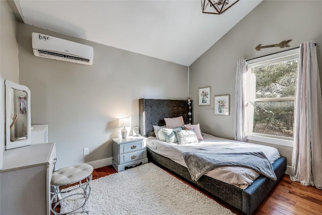 20008 Victoria Chase Rd, Lago Vista, TX 78645 - bedroom with an AC wall unit, lofted ceiling, and wood finished floors