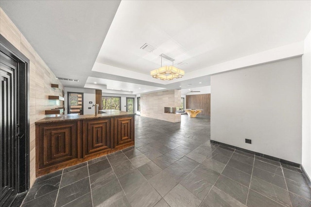 2817 Tradewind Dr, Spicewood, TX 78669 - empty room featuring stone tile flooring and a raised ceiling