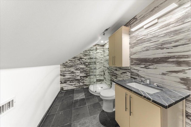 2817 Tradewind Dr, Spicewood, TX 78669 - full bath with a shower stall, vanity, vaulted ceiling, and tile walls