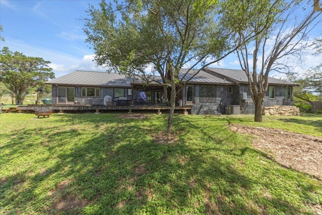 2817 Tradewind Dr, Spicewood, TX 78669 - back of house featuring a metal roof, a yard, a sunroom, and a deck