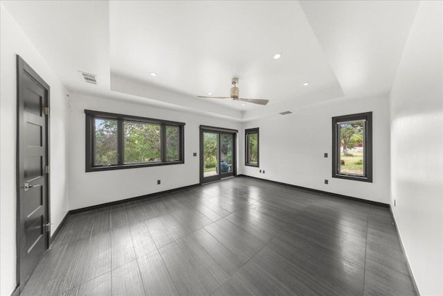 2817 Tradewind Dr, Spicewood, TX 78669 - unfurnished room featuring a tray ceiling, a ceiling fan, recessed lighting, and dark wood-type flooring