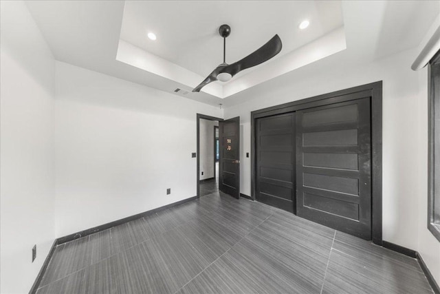 2817 Tradewind Dr, Spicewood, TX 78669 - unfurnished bedroom featuring a raised ceiling, a ceiling fan, and recessed lighting