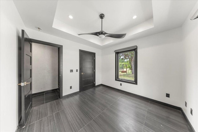 2817 Tradewind Dr, Spicewood, TX 78669 - unfurnished bedroom featuring a raised ceiling, ceiling fan, and recessed lighting