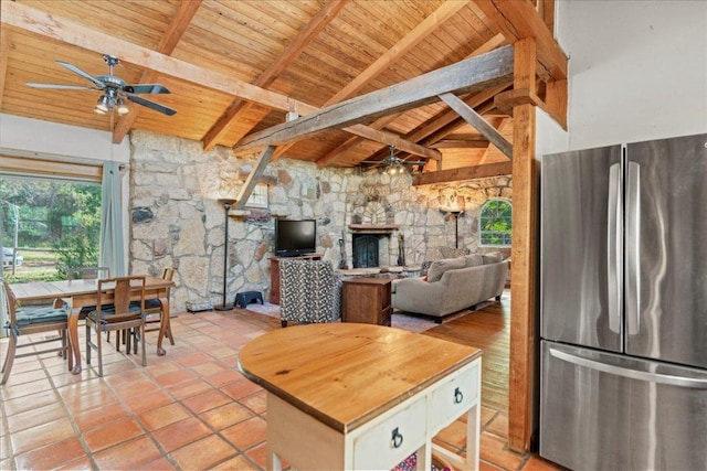 1800 N Rainbow Ranch Rd, Wimberley, TX 78676 - kitchen featuring freestanding refrigerator, ceiling fan, wooden ceiling, a stone fireplace, and butcher block counters