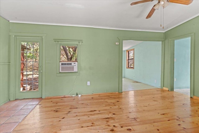1800 N Rainbow Ranch Rd, Wimberley, TX 78676 - spare room featuring cooling unit, wood finished floors, ceiling fan, and crown molding
