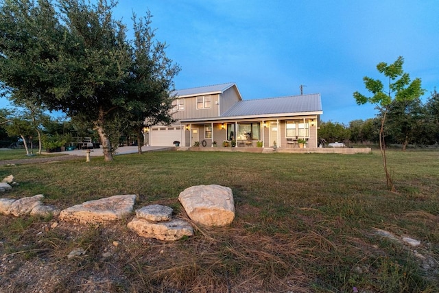 2025 Cripple Creek Stage Rd, Dripping Springs, TX 78620 - rear view of house with a porch, a lawn, a metal roof, and concrete driveway