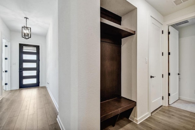 564 Biscayne Bay Bnd, Kyle, TX 78640 - mudroom featuring wood finished floors and a chandelier
