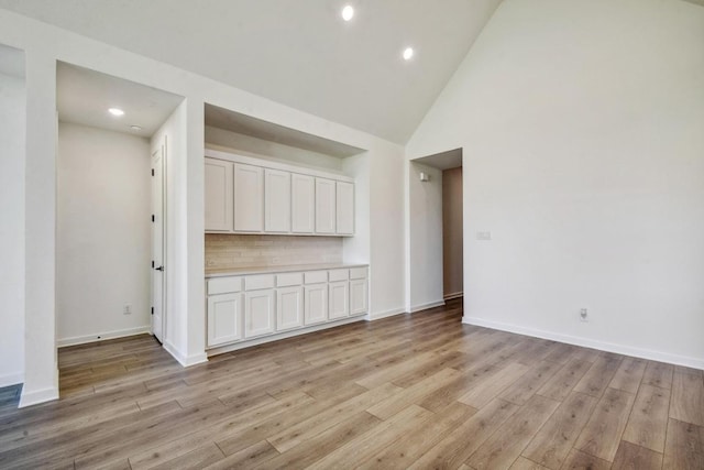564 Biscayne Bay Bnd, Kyle, TX 78640 - empty room with light wood finished floors, high vaulted ceiling, and recessed lighting