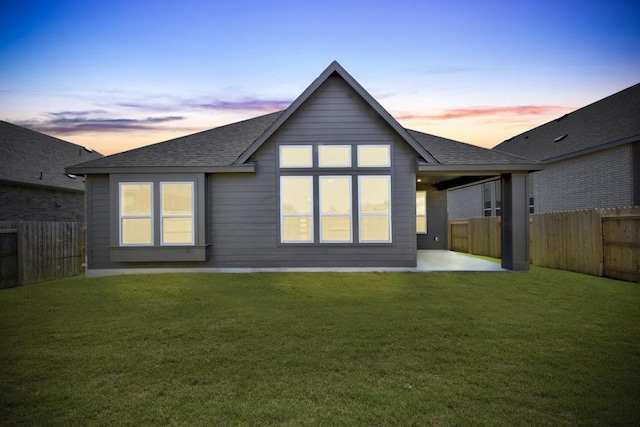 564 Biscayne Bay Bnd, Kyle, TX 78640 - back of house at dusk featuring a shingled roof, a fenced backyard, and a patio