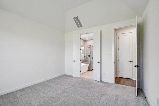 564 Biscayne Bay Bnd, Kyle, TX 78640 - unfurnished bedroom featuring carpet flooring, lofted ceiling, and ensuite bath