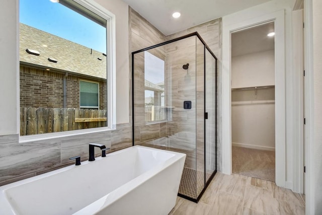 564 Biscayne Bay Bnd, Kyle, TX 78640 - full bathroom featuring a freestanding bath, a shower stall, a walk in closet, recessed lighting, and healthy amount of natural light