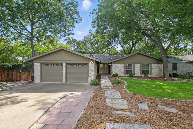 11915 River Oaks Trl, Austin, TX 78753 - view of front of home with a garage, driveway, and a chimney