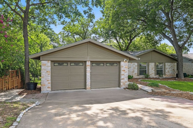 11915 River Oaks Trl, Austin, TX 78753 - view of front of property with stone siding, concrete driveway, and a garage