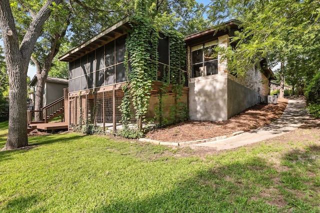 11915 River Oaks Trl, Austin, TX 78753 - view of property exterior with a sunroom, a yard, and stairway
