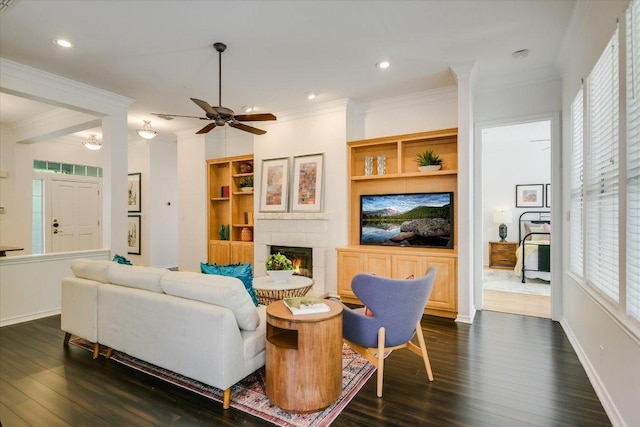 2211 Wilson St, Austin, TX 78704 - living area featuring crown molding, a warm lit fireplace, ceiling fan, dark wood finished floors, and recessed lighting