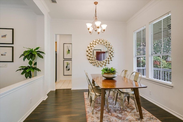 2211 Wilson St, Austin, TX 78704 - dining area featuring wood finished floors, ornamental molding, and a chandelier