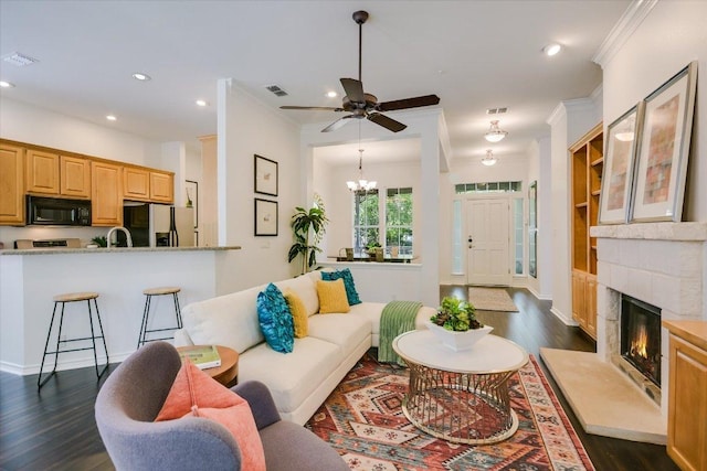 2211 Wilson St, Austin, TX 78704 - living room featuring dark wood-style flooring, ceiling fan, recessed lighting, a high end fireplace, and crown molding