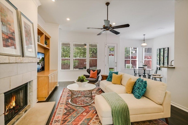 2211 Wilson St, Austin, TX 78704 - living room with dark wood-type flooring, recessed lighting, a ceiling fan, a fireplace, and crown molding