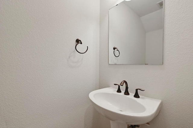 12304 Buvana Dr, Austin, TX 78739 - bathroom featuring a sink and vaulted ceiling