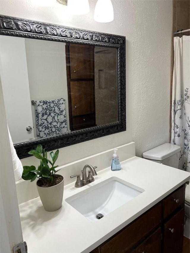 1104 Speer Ln, Austin, TX 78745 - full bathroom with vanity, a textured wall, and a shower with shower curtain