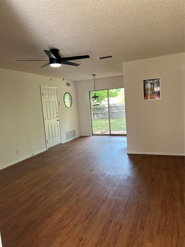 1104 Speer Ln, Austin, TX 78745 - unfurnished room featuring dark wood finished floors, a textured ceiling, and ceiling fan