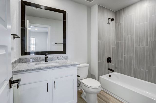 17309 Howdy Way, Manor, TX 78653 - full bathroom featuring vanity, bathtub / shower combination, and wood finished floors