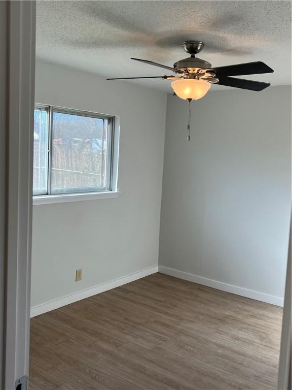 5802 Cherry Park, Austin, TX 78745 - spare room with a textured ceiling, wood finished floors, and a ceiling fan