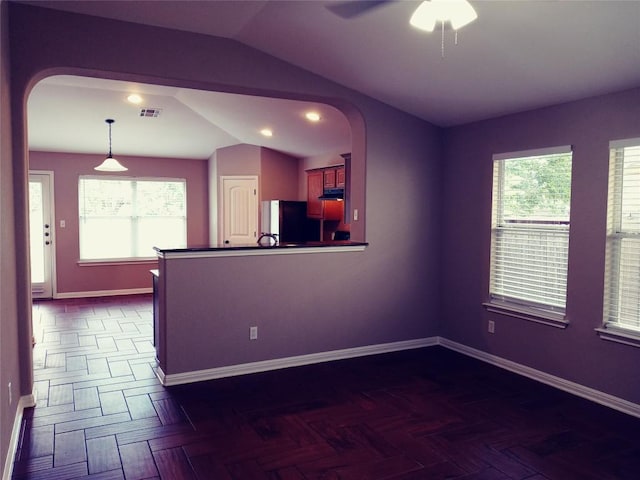 3304 Wickham Ln, Austin, TX 78725 - kitchen with arched walkways, lofted ceiling, plenty of natural light, under cabinet range hood, and refrigerator