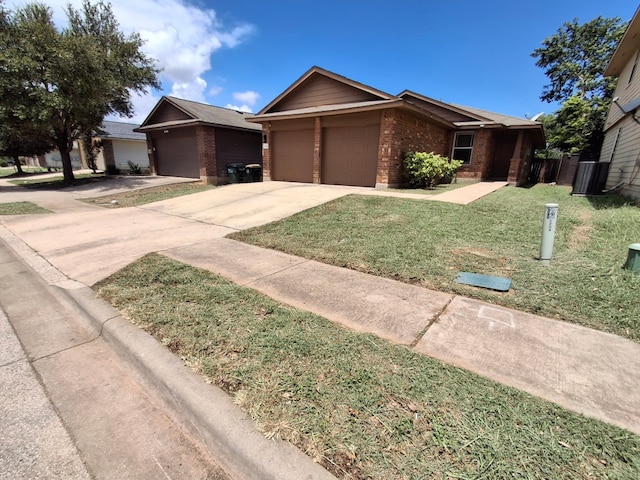 3304 Wickham Ln, Austin, TX 78725 - single story home with brick siding, an attached garage, concrete driveway, and a front yard