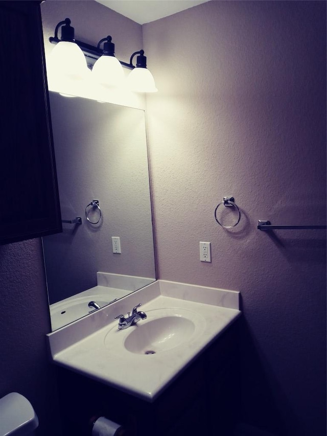 3304 Wickham Ln, Austin, TX 78725 - half bathroom featuring vanity and a textured wall